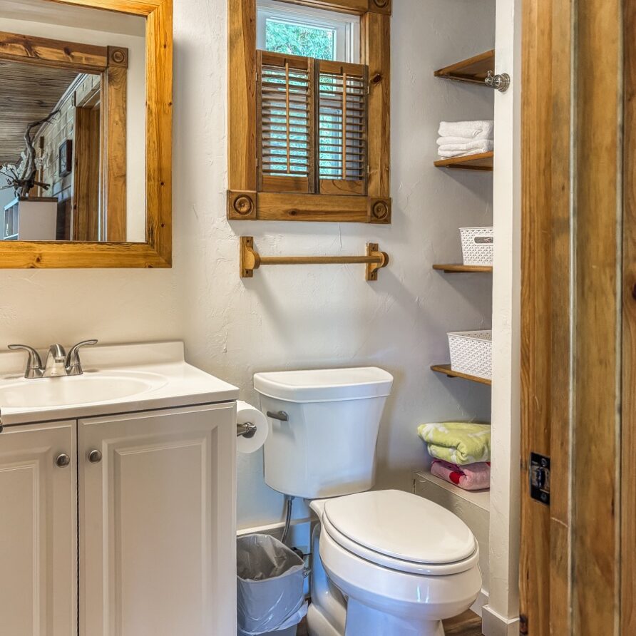 Full-size bathroom stocked with towels, shampoo, and a hair dryer